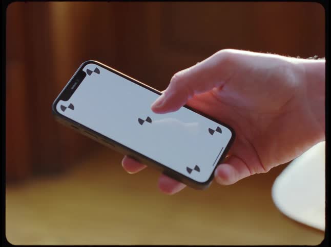 Man scrolls his thumb on smartphone screen