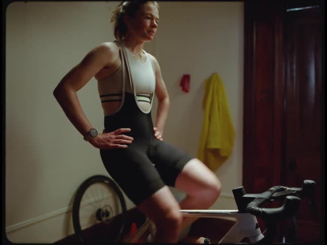A woman riding an exercise bicycle