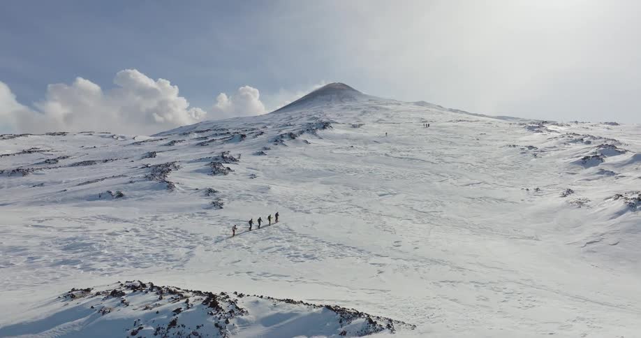 A group of people climbing up a mountain