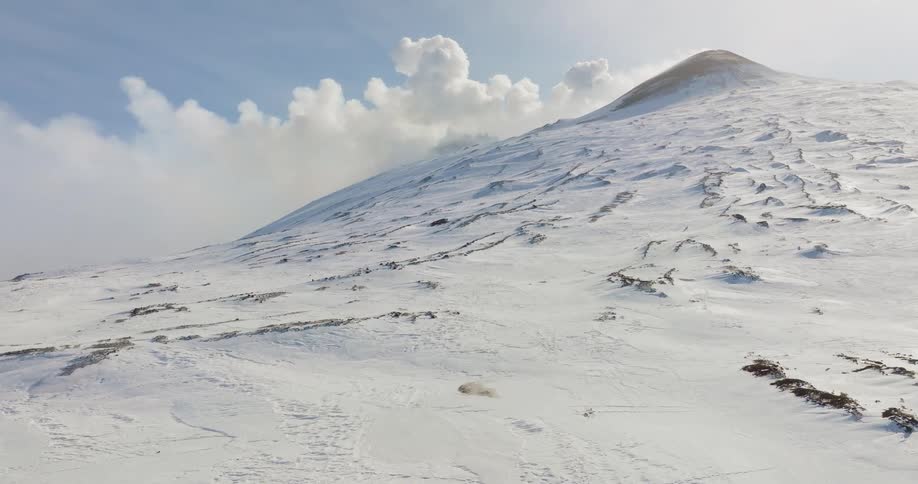Snow and ice cover the side of a mountain