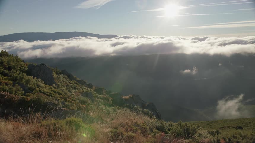 Time-lapse of clouds moving amongst mountaintops