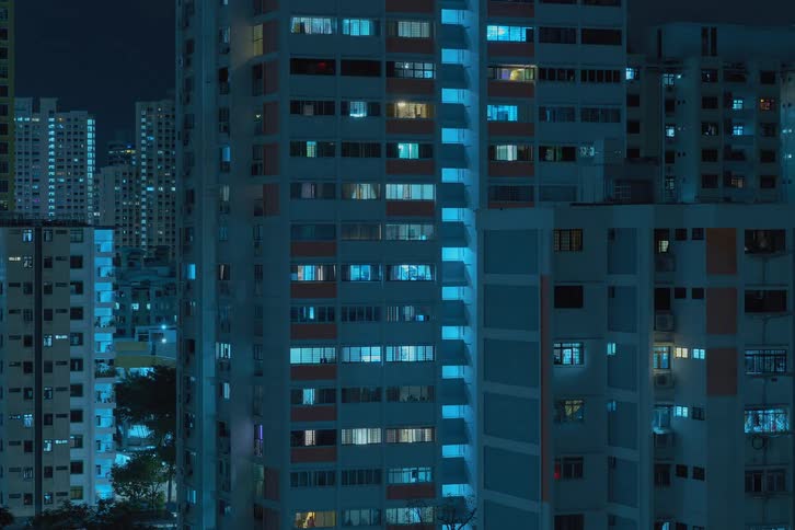 Time lapse of apartment buildings with flickering lights from the windows