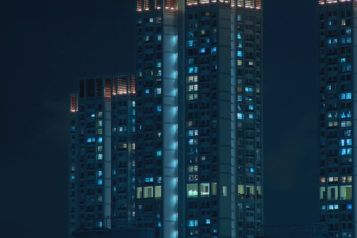 Lights emitted from skyscraper blinking and flickering as time passes