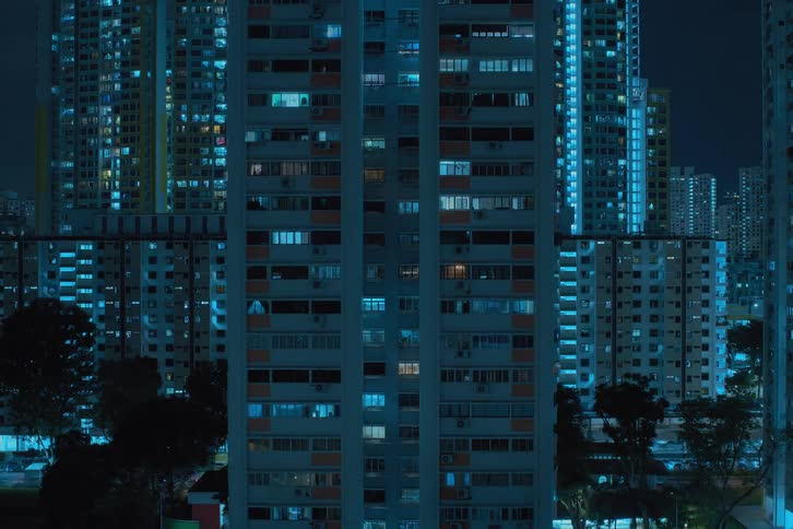 Aerial view of a city with lights pulsing and blinking during night time is displayed