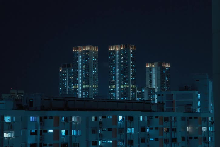 A time lapse of city buildings shows lights in windows blinking and flickering