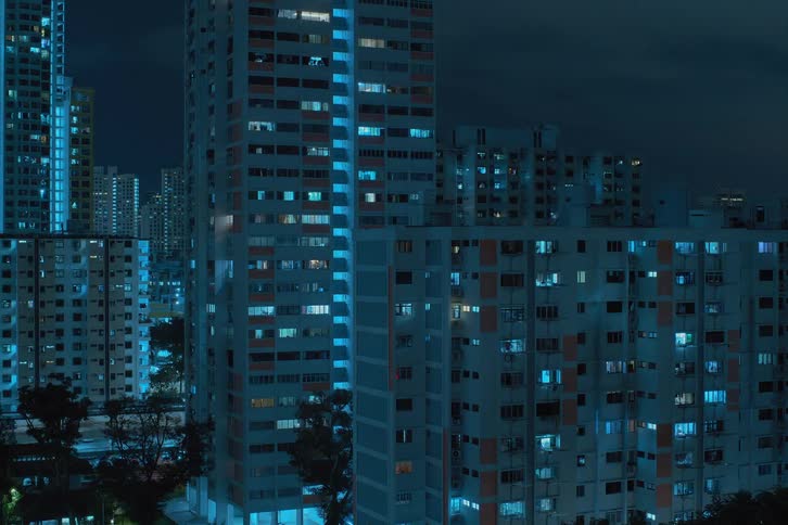 City lights twinkling from within skyscrapers at night