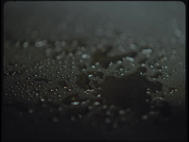 Water droplets are falling onto the pavement