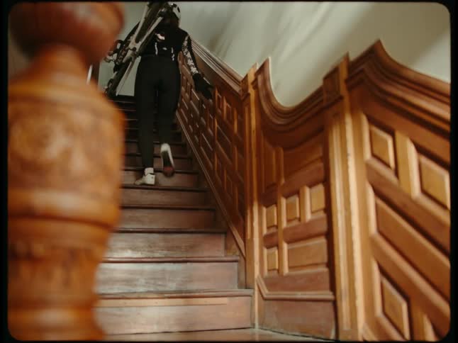 A person is walking up a staircase with their bicycle