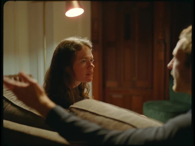 A young couple is inside and looks like they are fighting