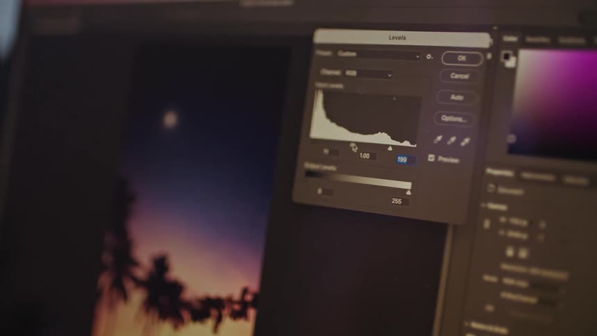 A computer monitor is shown with an image of a photo and a color picker being used by someone indicated by the mouse pointer moving