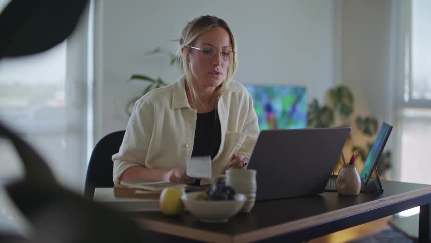 A woman sits at her desk