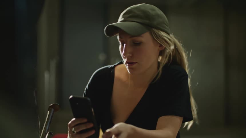 A woman is looking at her cell phone