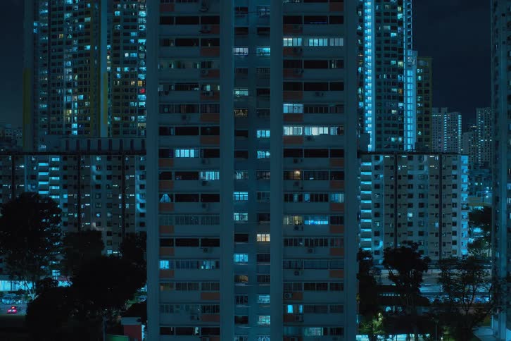 City lights twinkling from within skyscrapers at night