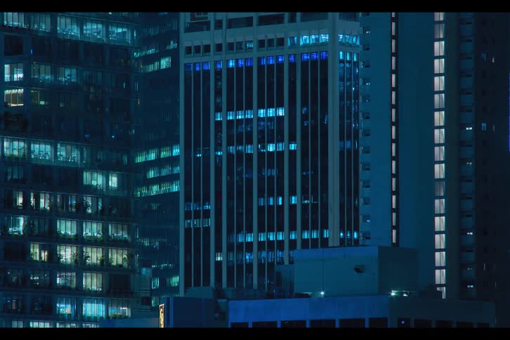 Lights in shades of blue flash and blink inside futuristic towers and buildings