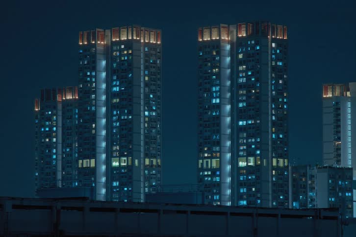 City lights twinkling from skyscrapers at night
