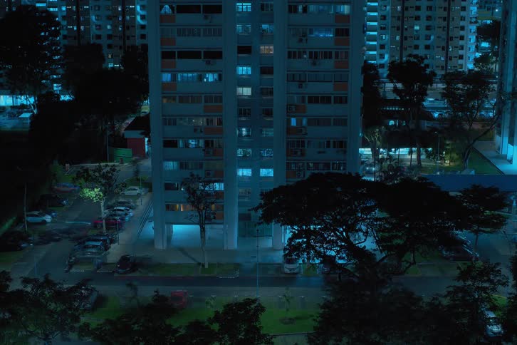 A time lapse shows the exterior of a high rise building only at nighttime