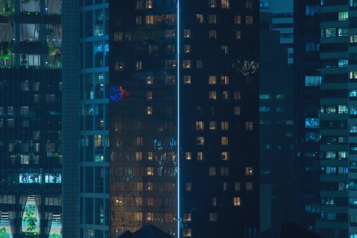 Lights flash and flicker inside futuristic towers and buildings in a modern city