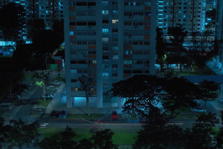 A time lapse of a city building at night with cars coming and going