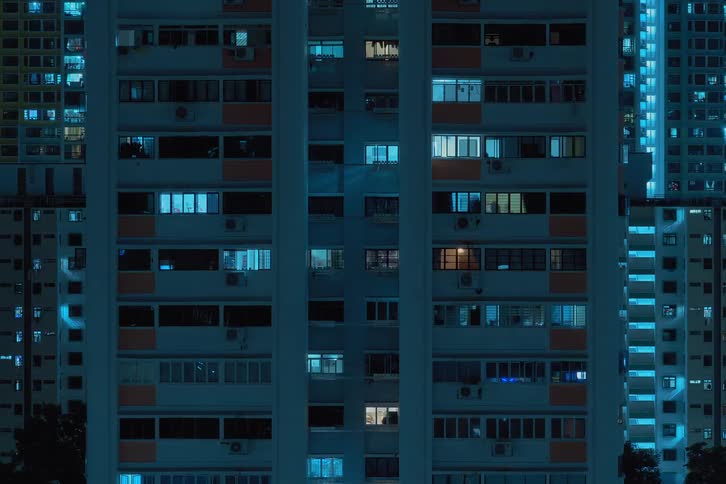 Time lapse of apartment buildings with flickering lights from the windows