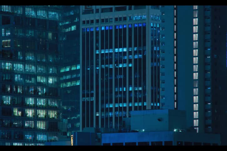 Time lapse of apartment buildings in the city at night blinking and flickering