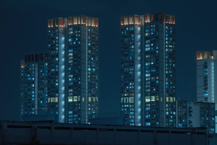 Lights shining from downtown building windows blink and flicker as time passes