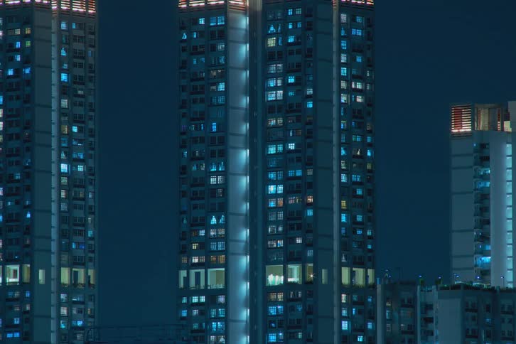 Time lapse of tall buildings with windows flickering and flashing