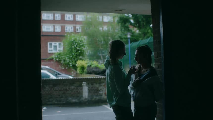 Two girls argue by the parking lot