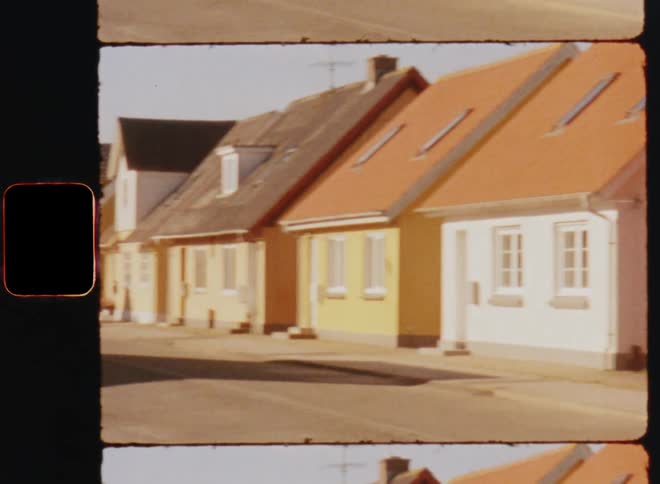 Single family homes sit close together in a neighborhood