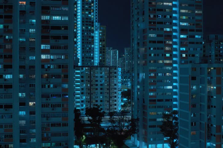 Time lapse view of a downtown city with pulsing neon lights during night time