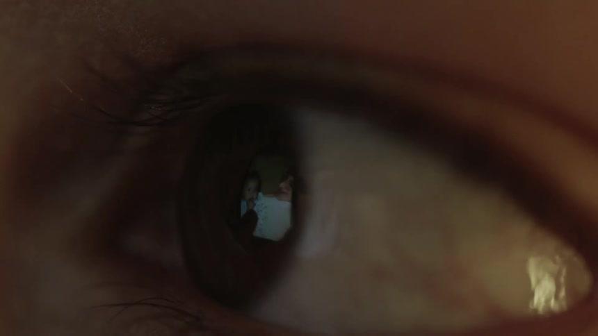 A screen reflects in a persons eyeball