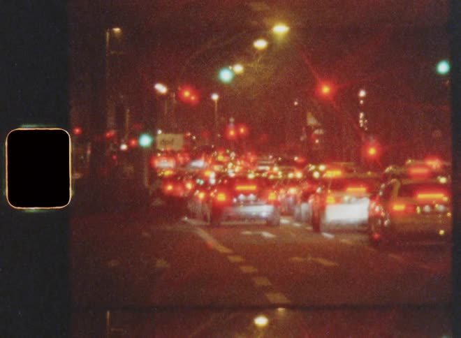 Cars waiting at red light at night