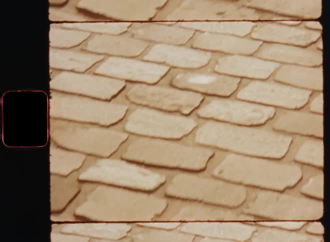 A pointof view shot of a brick street or road while walking forward
