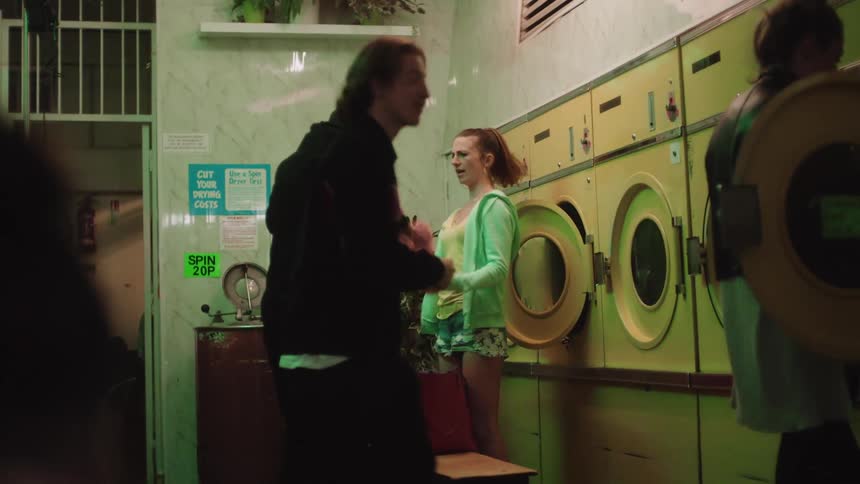 Woman picks up laundry with her friends in laundry shop