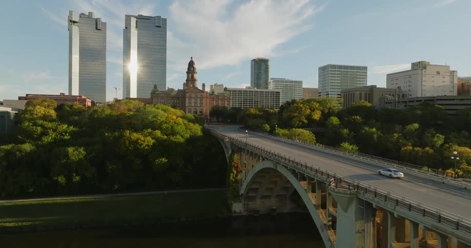 Aerial view going over fort worth tx bridge and skyline with mild traffic