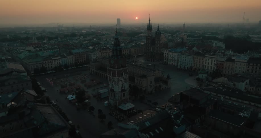 Aerial view of sunset behind the towers of a cathedral on an european city at evening