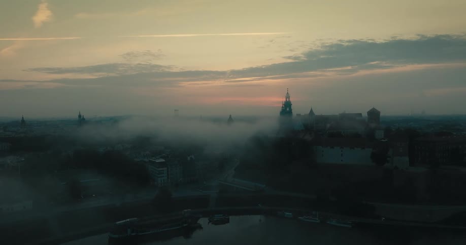Fog rolls over the city at sunrise