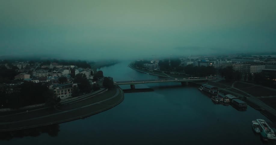 Cars are crossing a bridge over a body of water