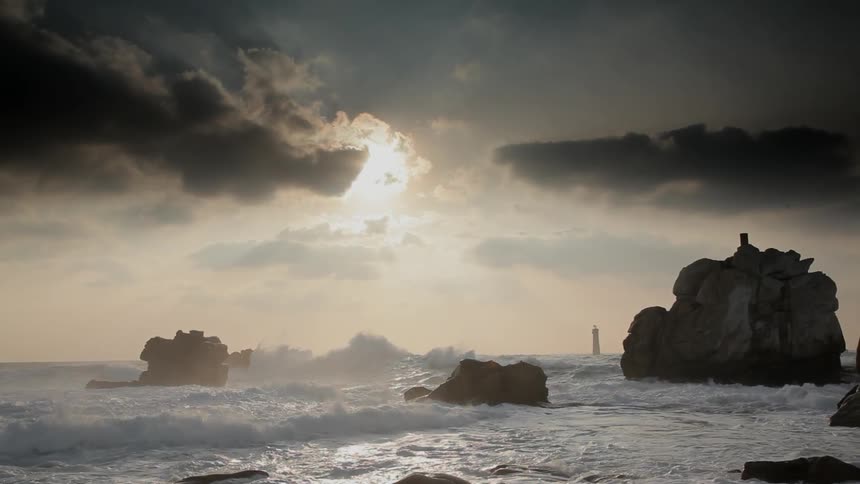 Ocean waves crash into rock formations on the beach