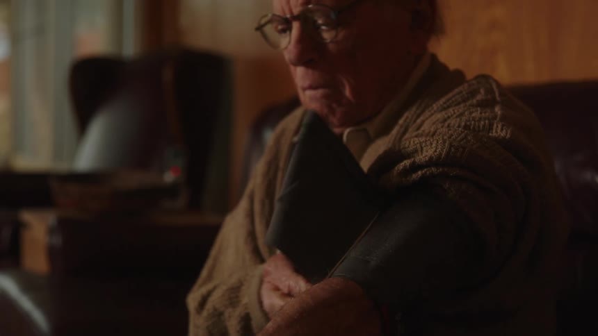 An old elderly man is taking his blood pressure in the middle of the day time