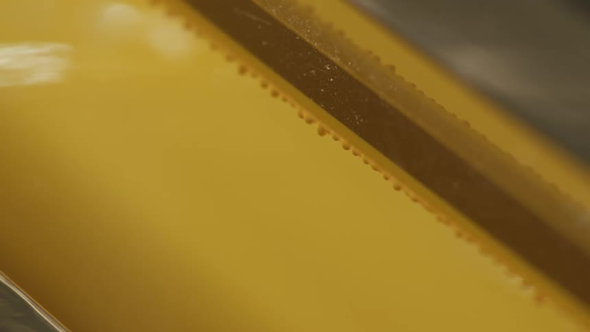 Yellow paint dripping off a frame