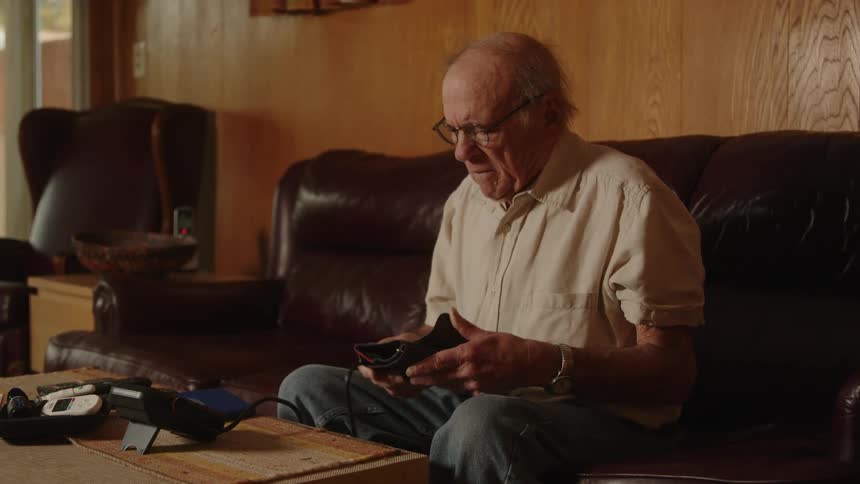 A man records his blood pressure in a notebook