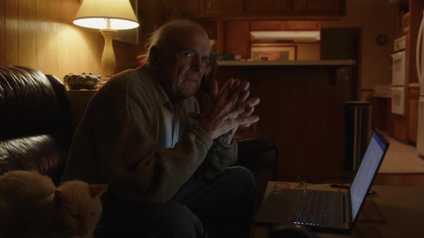 A man is reading something on his laptop