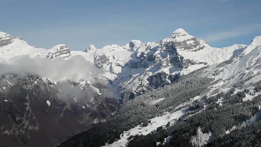 Clouds on a snowy mountain