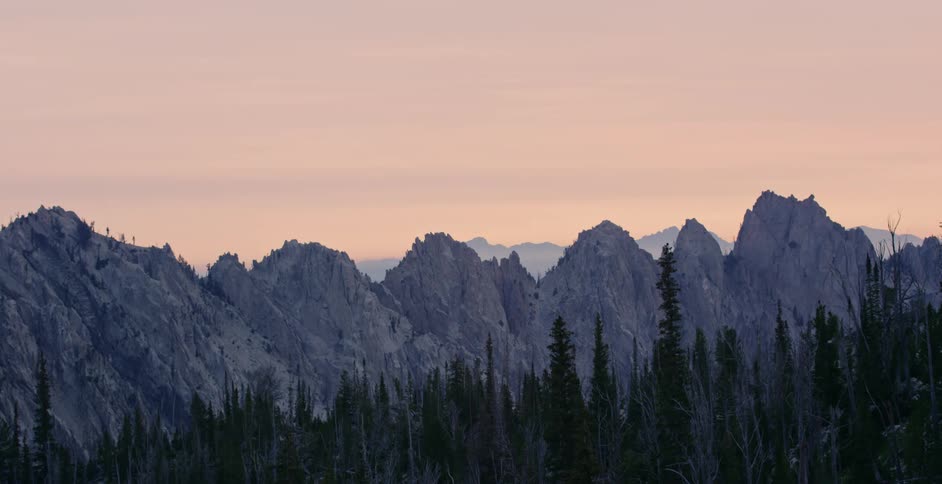 Aerial view of the sun setting above the mountains