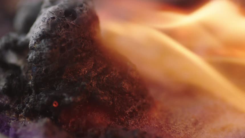 Fire burns on a piece of coal
