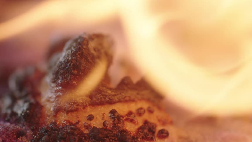 Close up view of a bonfire is displayed outdoors