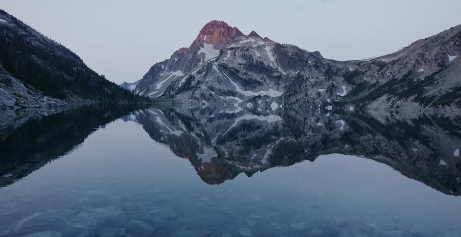 A lake in front of a mountain range