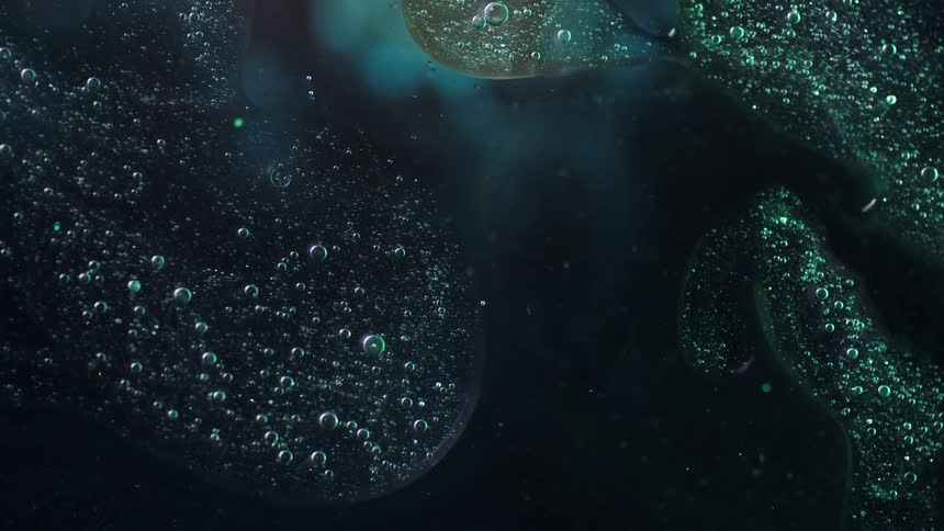 Abstract footage of bubbles in liquid as it moves