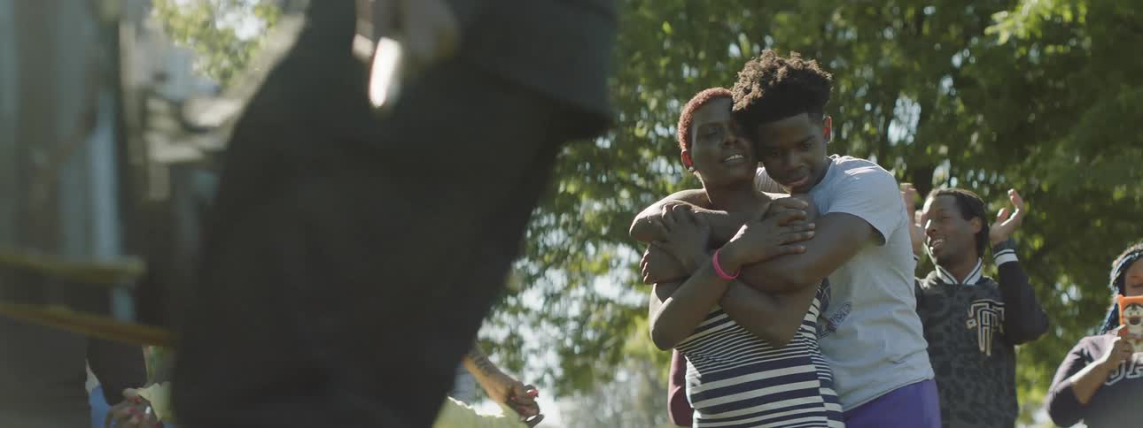 A group of people dance outdoors during the day