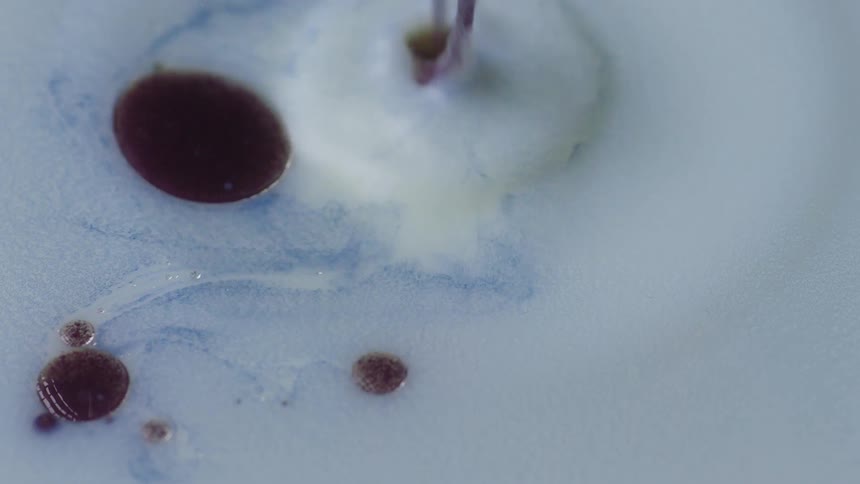 Liquid dye moving and dropping in to white liquid
